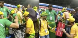 Brasileiros juntam o lixo em estádio depois da vitória da seleção